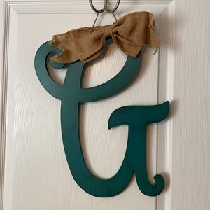 Wooden script letter “G” with burlap bow